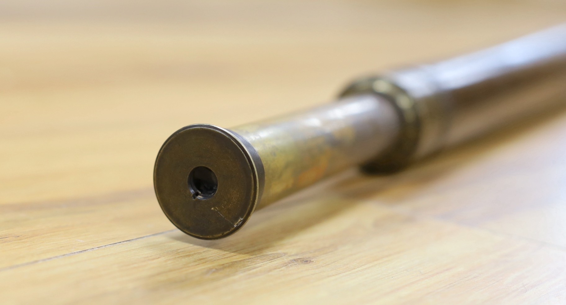 A single draw brass and leather Watkins & Hill telescope, total extended length 74.5cm